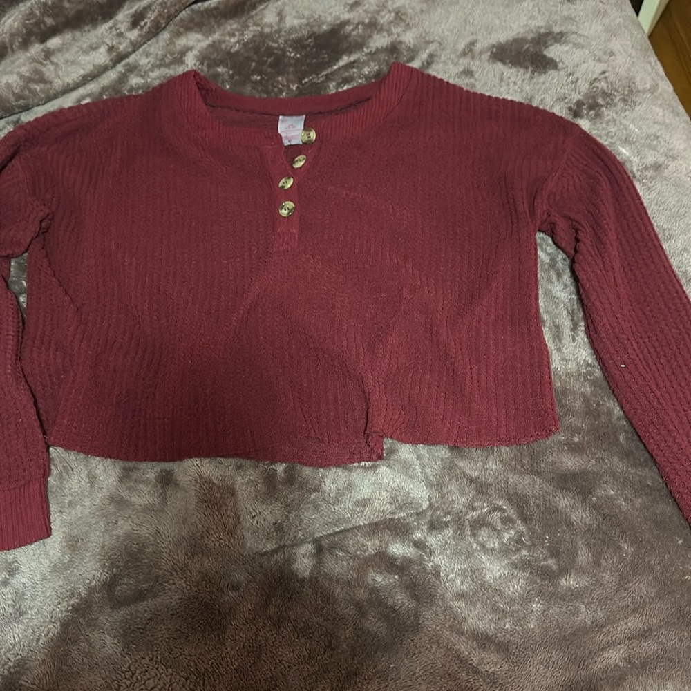 I’m selling this red top with buttons in a size  L if anyone is interested